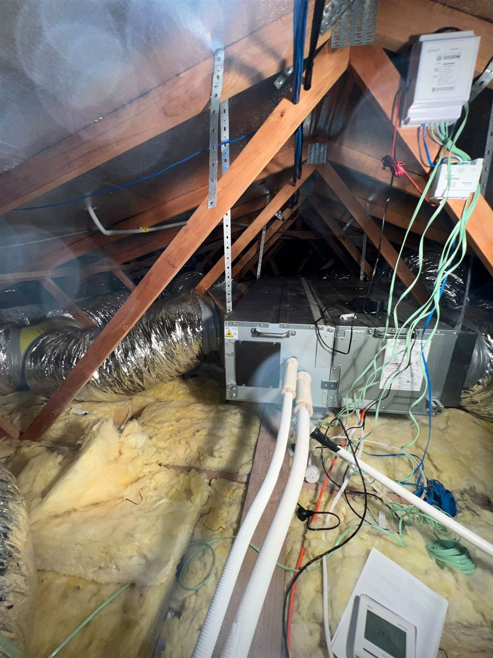 Ducted air conditioning indoor unit installed in a roof space with insulated flexible ducts