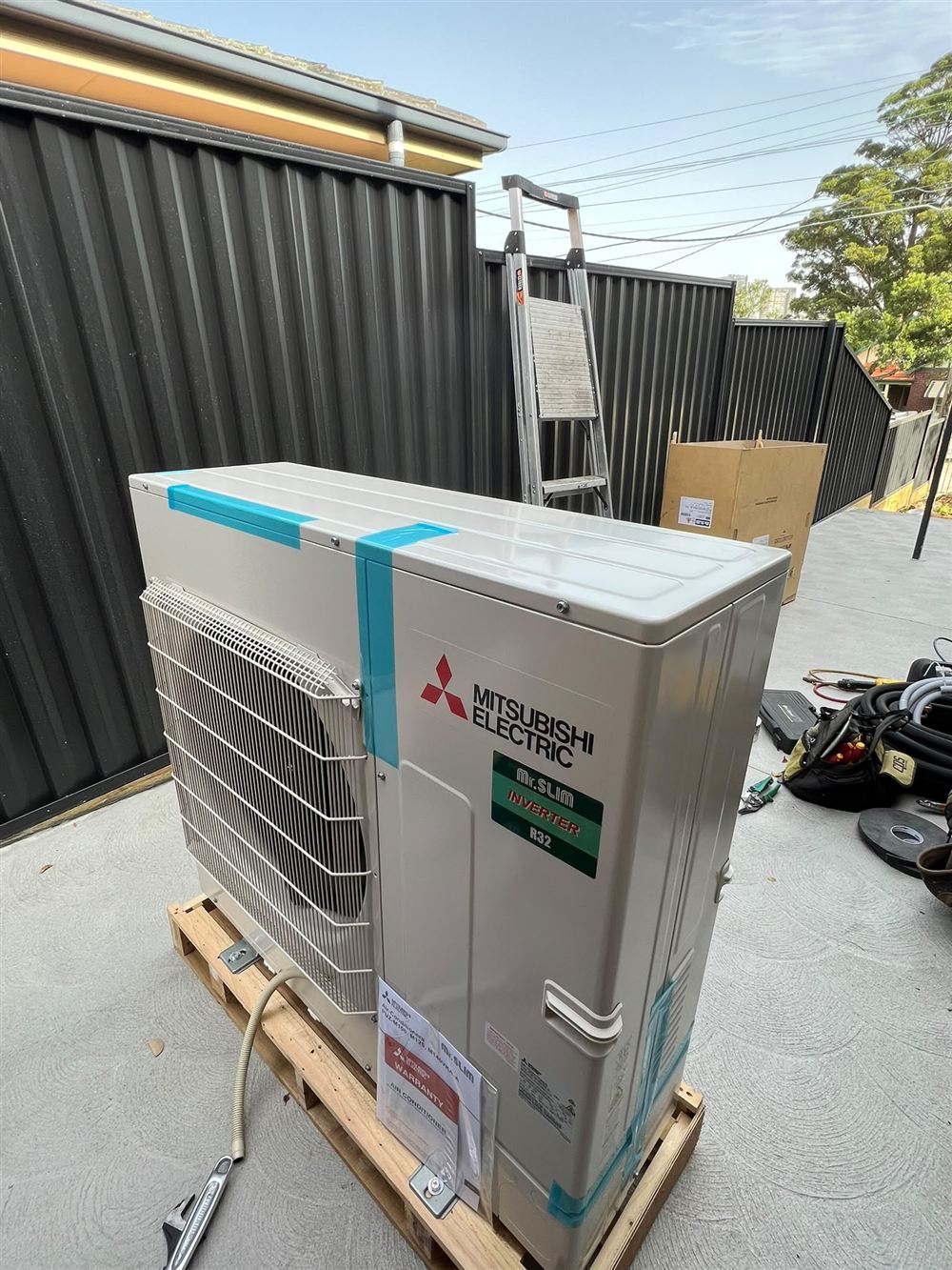 New inverter outdoor air conditioning unit on a pallet ready for installation