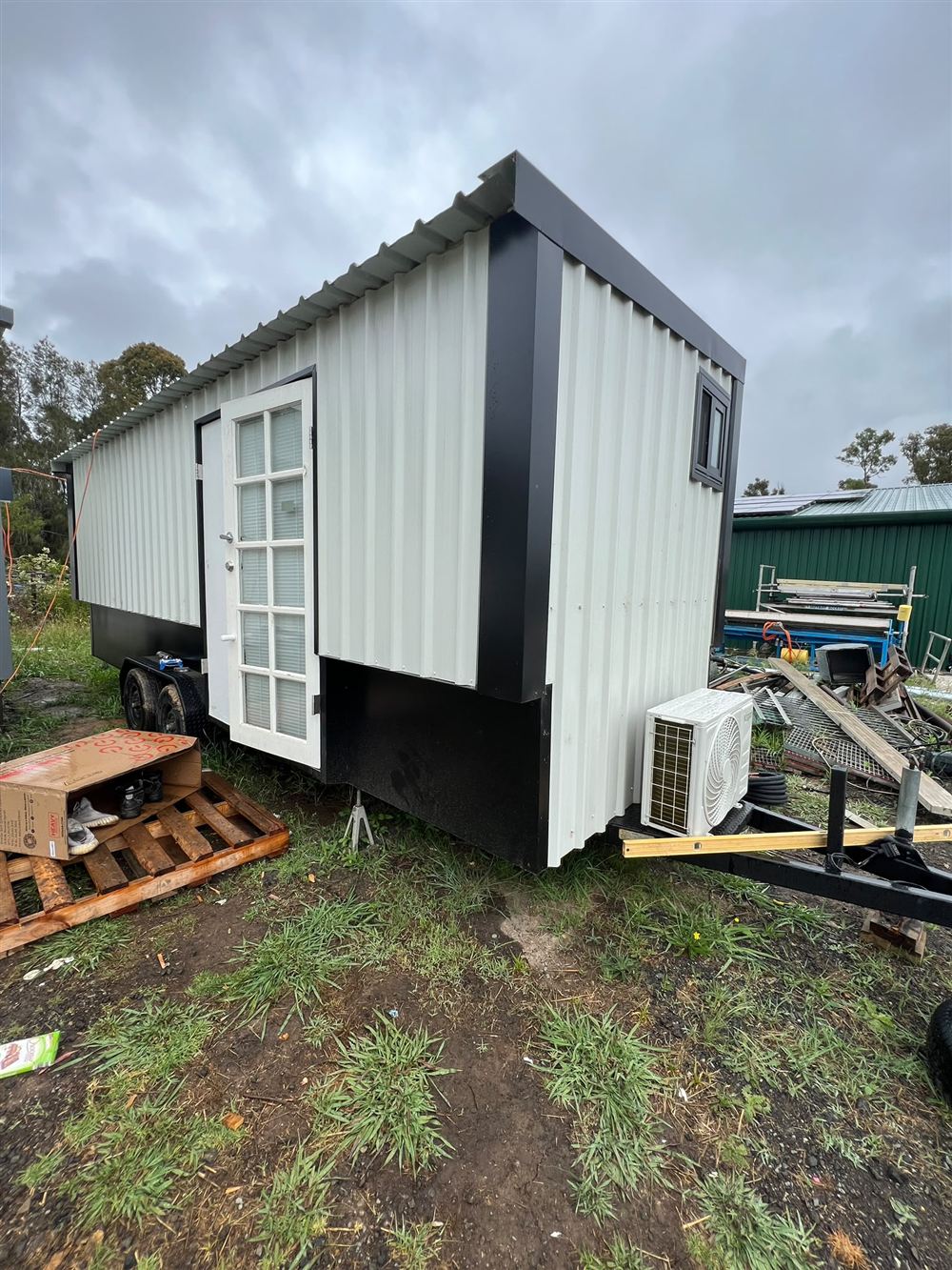 Outdoor air conditioning unit installed on the trailer of a tiny home
